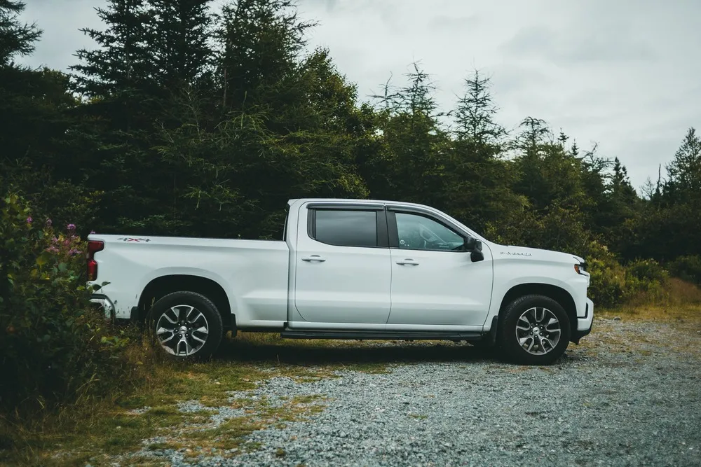 Chevrolet Silverado parked by the trees