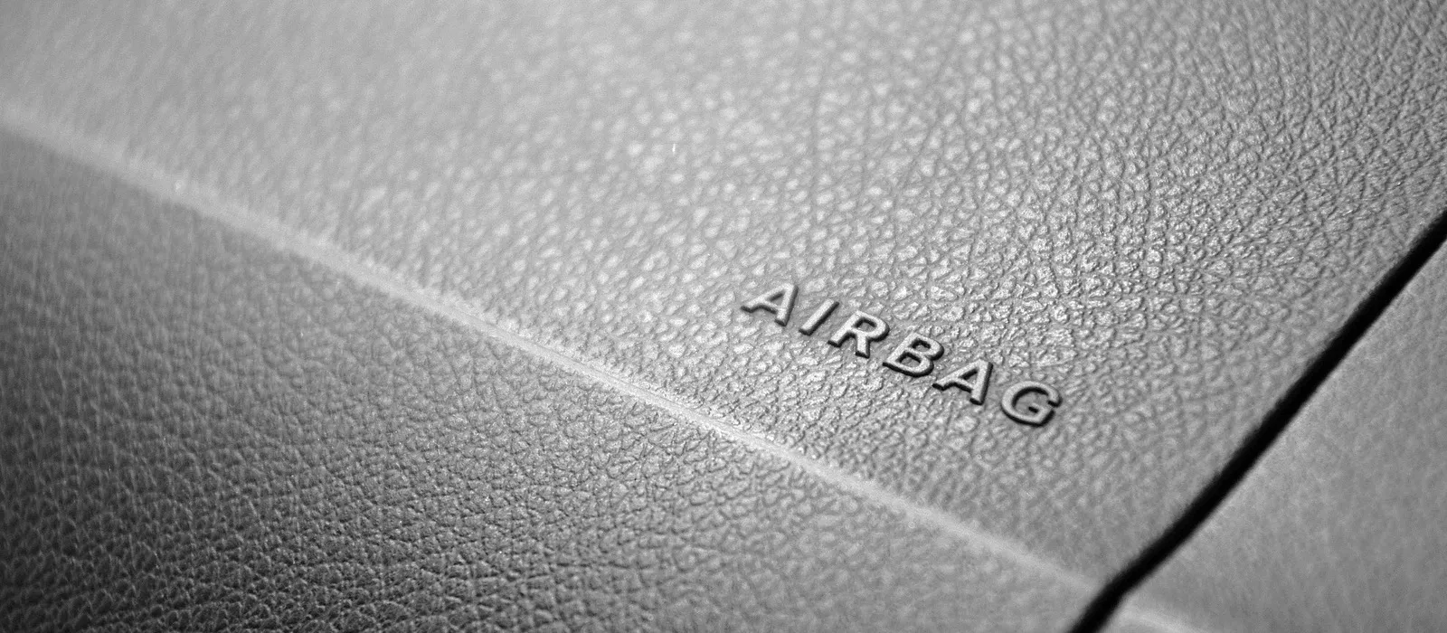 Close view of dashboard trim embossed with the word airbag