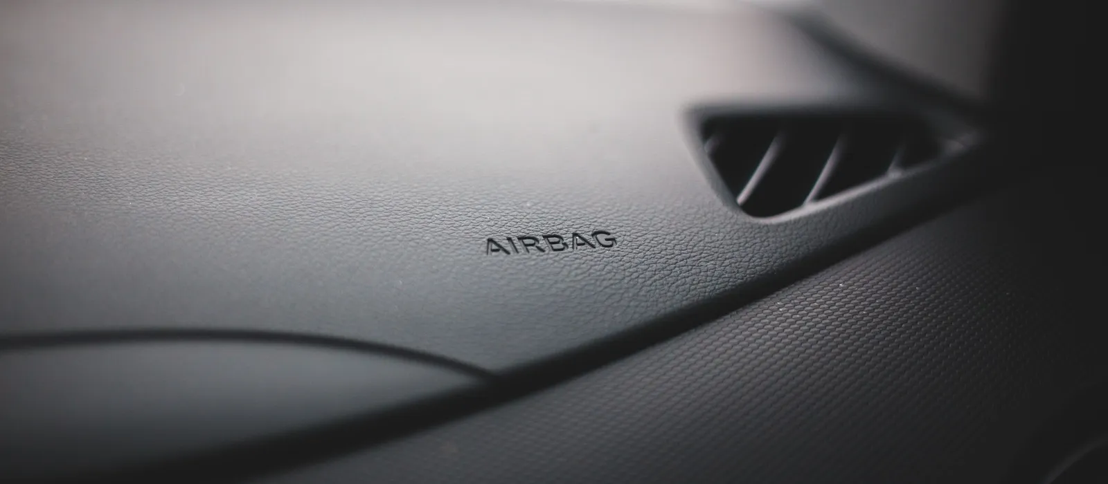 Dashboard trim embossed with the word airbag