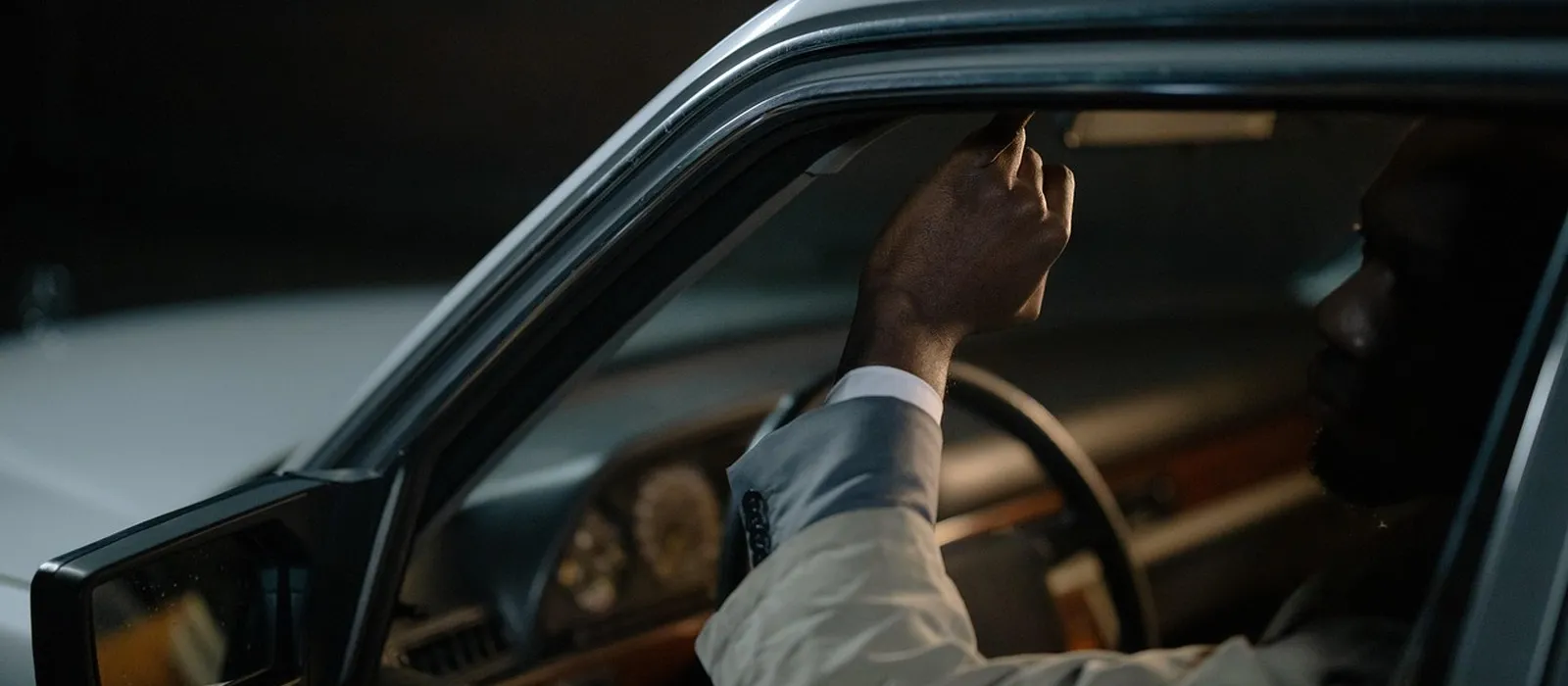 Driver fastening a seat belt inside a vehicle